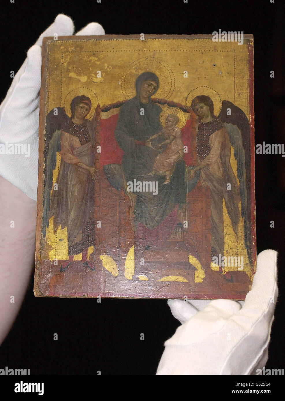 A 13th century gold-ground panel painting by Italian master Cimabue, measuring only ten by eight inches, displayed at Sotheby's, London, before being transported to the National Gallery which negotiated with the auction house to save it for the nation. * The painting will be known as the Benacre Madonna and Child after Benacre Hall in Suffolk, seat of the Gooch family, the house contents auction of which led to Sotheby's art expert Richard Charlton-Jones recognising it as a masterpiece. Stock Photo