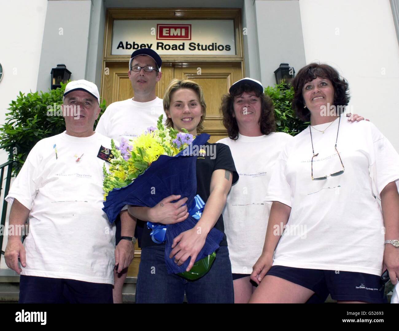 Spice Girl Mel C greets Dave Williams, Ian Gibbons, Lois Douglas and Julie Bond outside the famous Abbey Road Studios in London. The group walked from Liverpool to the studio made famous by The Beatles to raise funds for the Linda McCartney Centre. Stock Photo