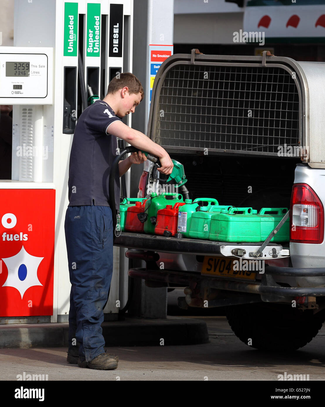 A person fills up petrol tanks at a petrol station in Linlithgow, after