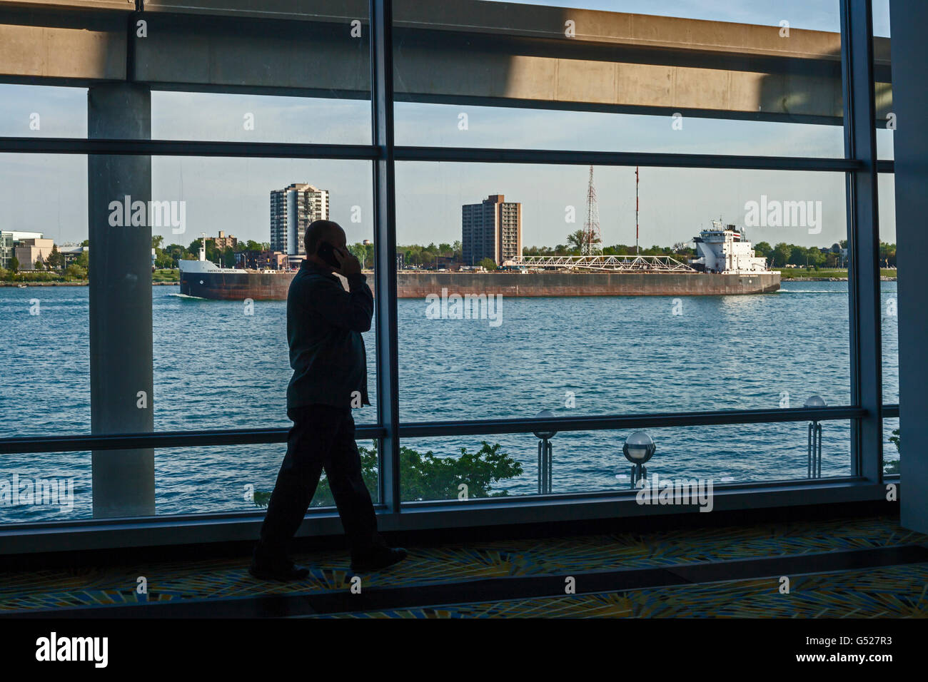 Detroit, Michigan - A convention participant talks on a cell phone during a break in a meeting at Cobo Center. Stock Photo