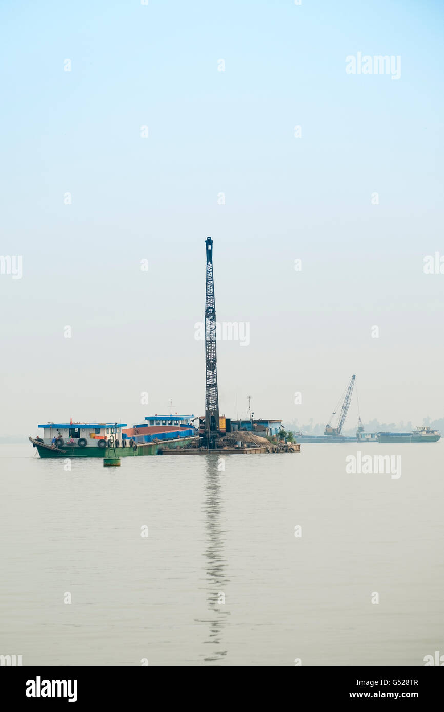 Dredgers mining for sand and gravel on the Mekong Stock Photo