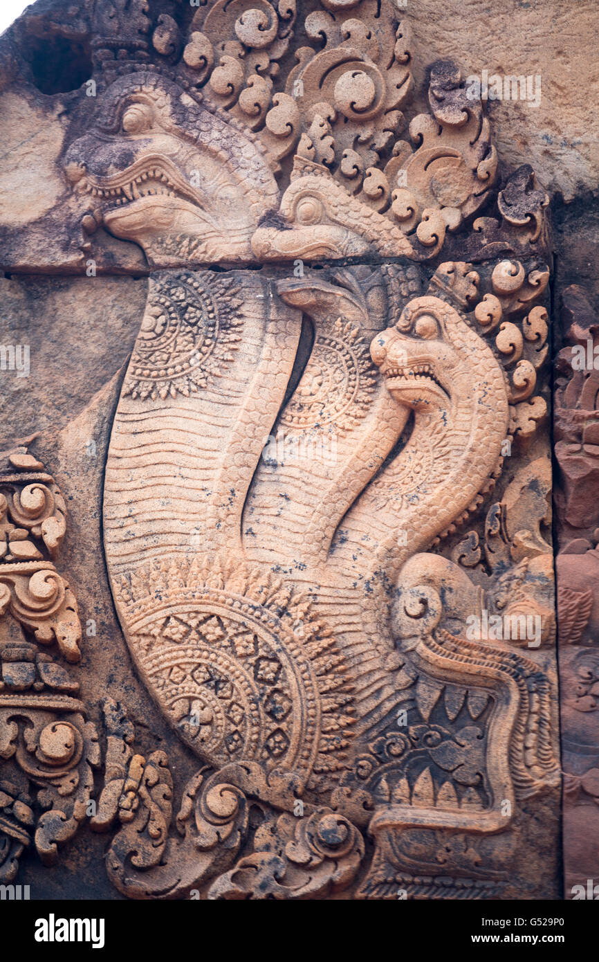 Naga serpent carvings on a bas relief at Banteay Srei - a 10th-century Cambodian temple dedicated to the Hindu god Shiva at Angkor, Cambodia Stock Photo