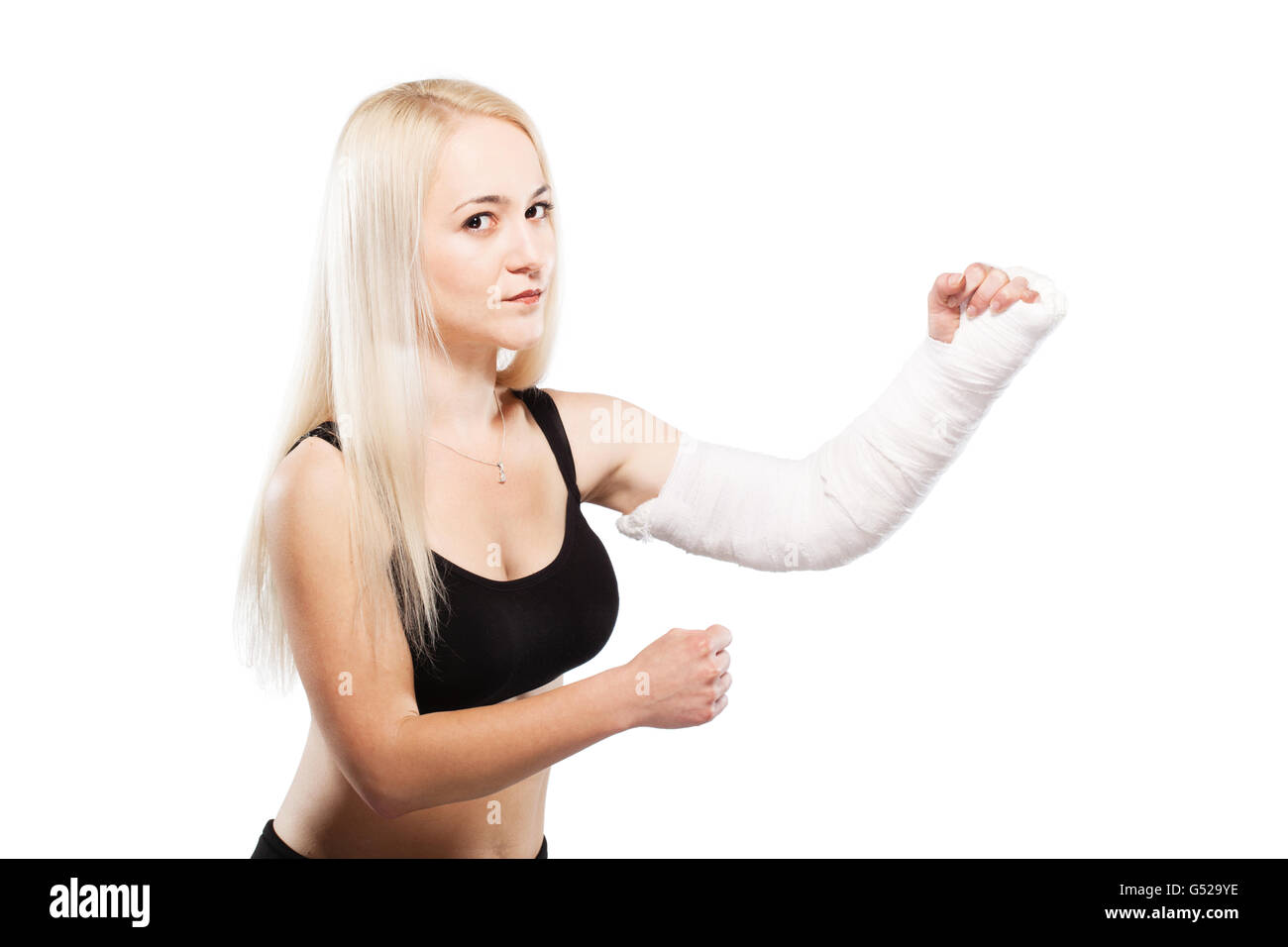 Fitness blond girl with a broken arm in plaster, boxing pose Stock Photo