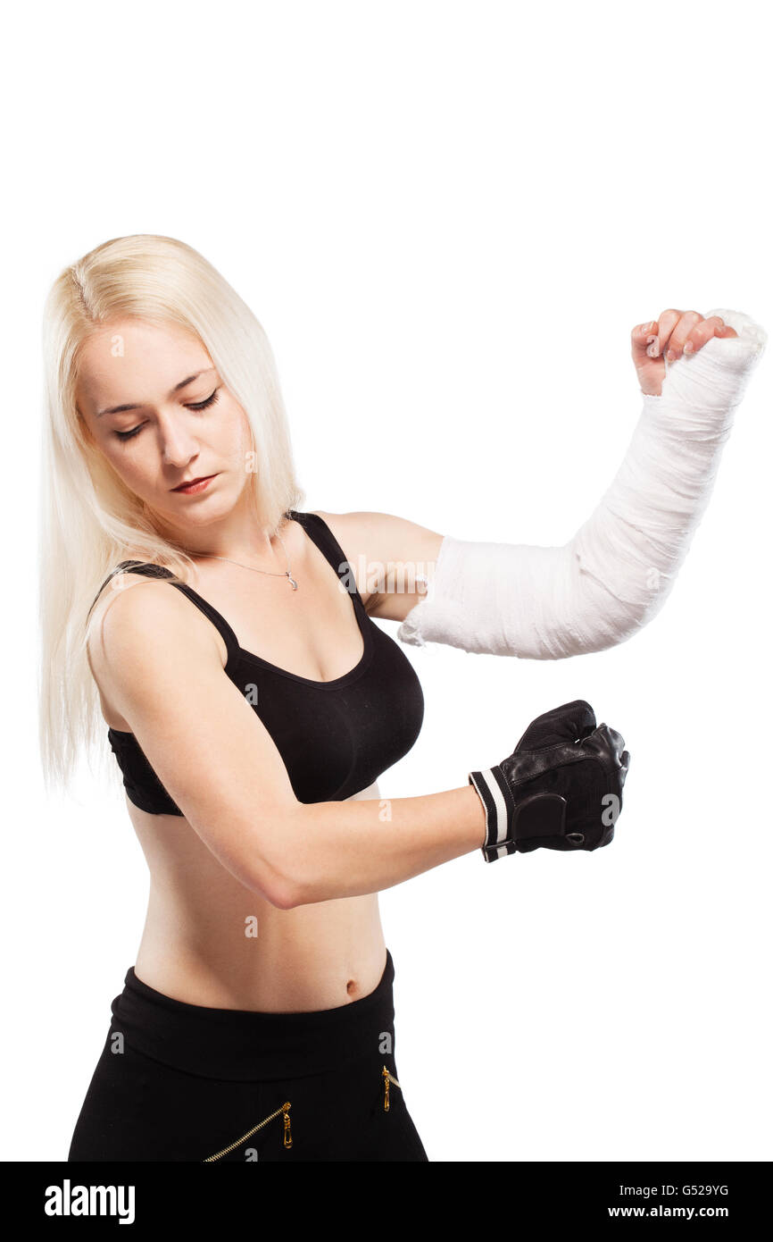 Fitness blond girl with a broken arm in plaster, boxing pose Stock Photo