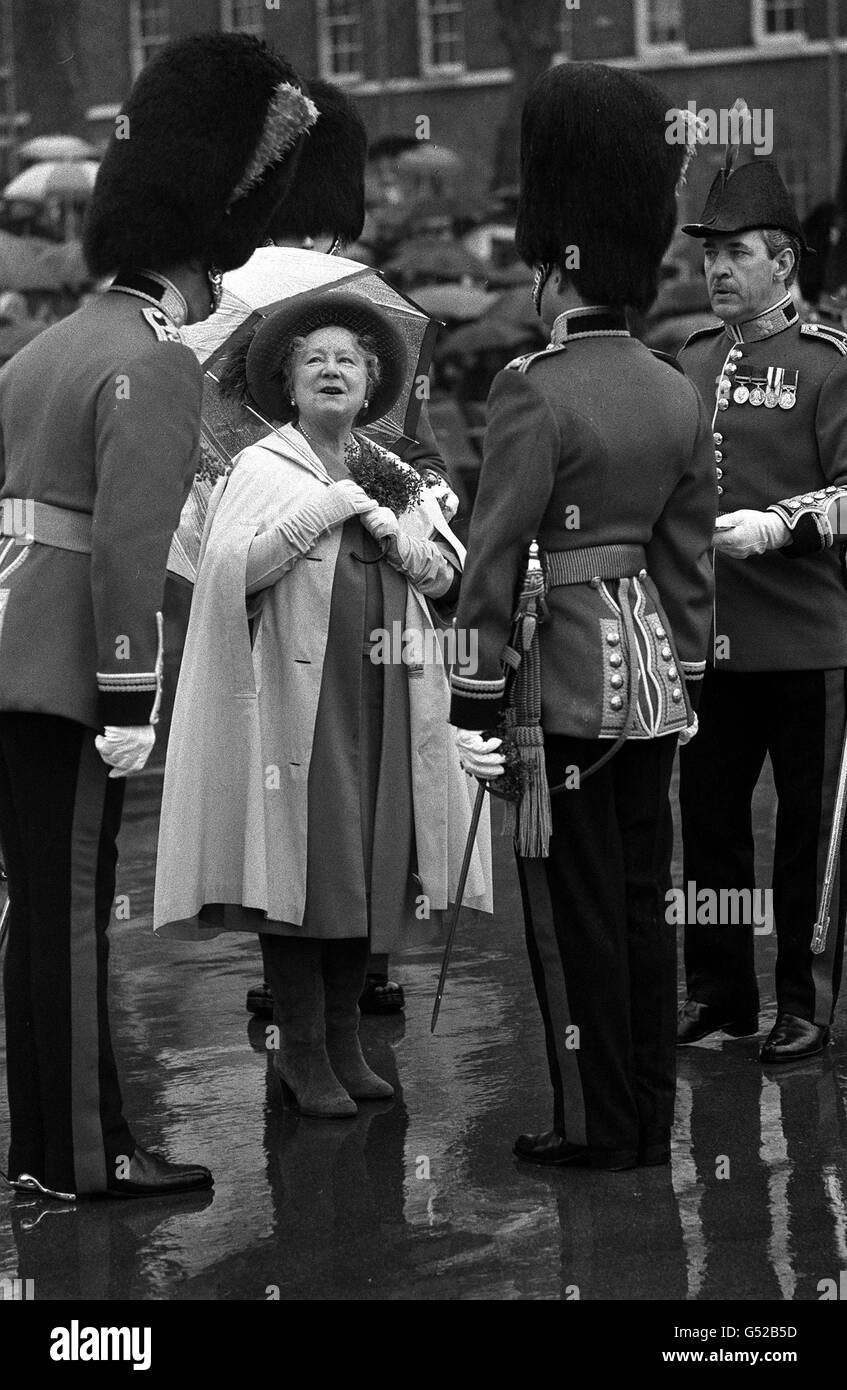 QUEEN MOTHER ON ST. PATRICK'S DAY 1980: An ample amount of shamrock adorns the Queen Mother's rain cape at Victoria barracks, Windsor, where she presented officers and men with shamrock during their traditional St. Patrick's Day parade. (NEG. NO. 191876-2) Stock Photo