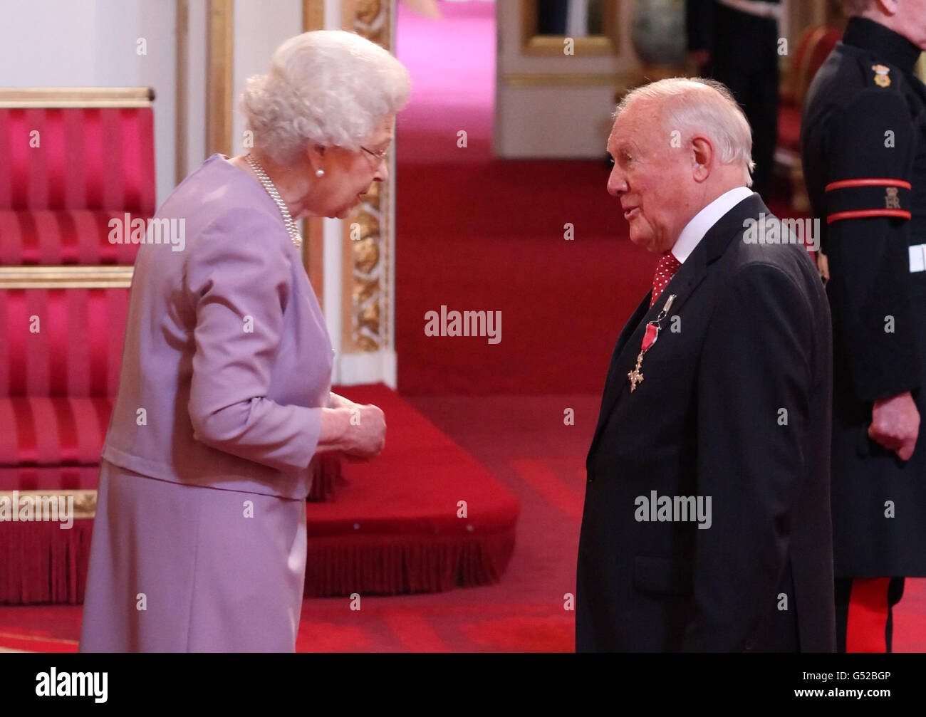 Stuart Hall is made an Officer of the British Empire (OBE) by Queen Elizabeth II during an Investiture ceremony at Buckingham Palace, London. Stock Photo