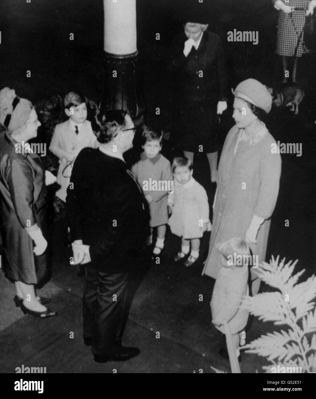 Two year old Prince Edward, stands smartly to attention at his mother's side as Queen Elizabeth II is greeted by Norman Hogg, Lord Provost of Aberdeen. In the background are, from left; Prince Andrew, six; Viscount Linley, four; and Lady Sarah Armstrong-Jones, two. Stock Photo