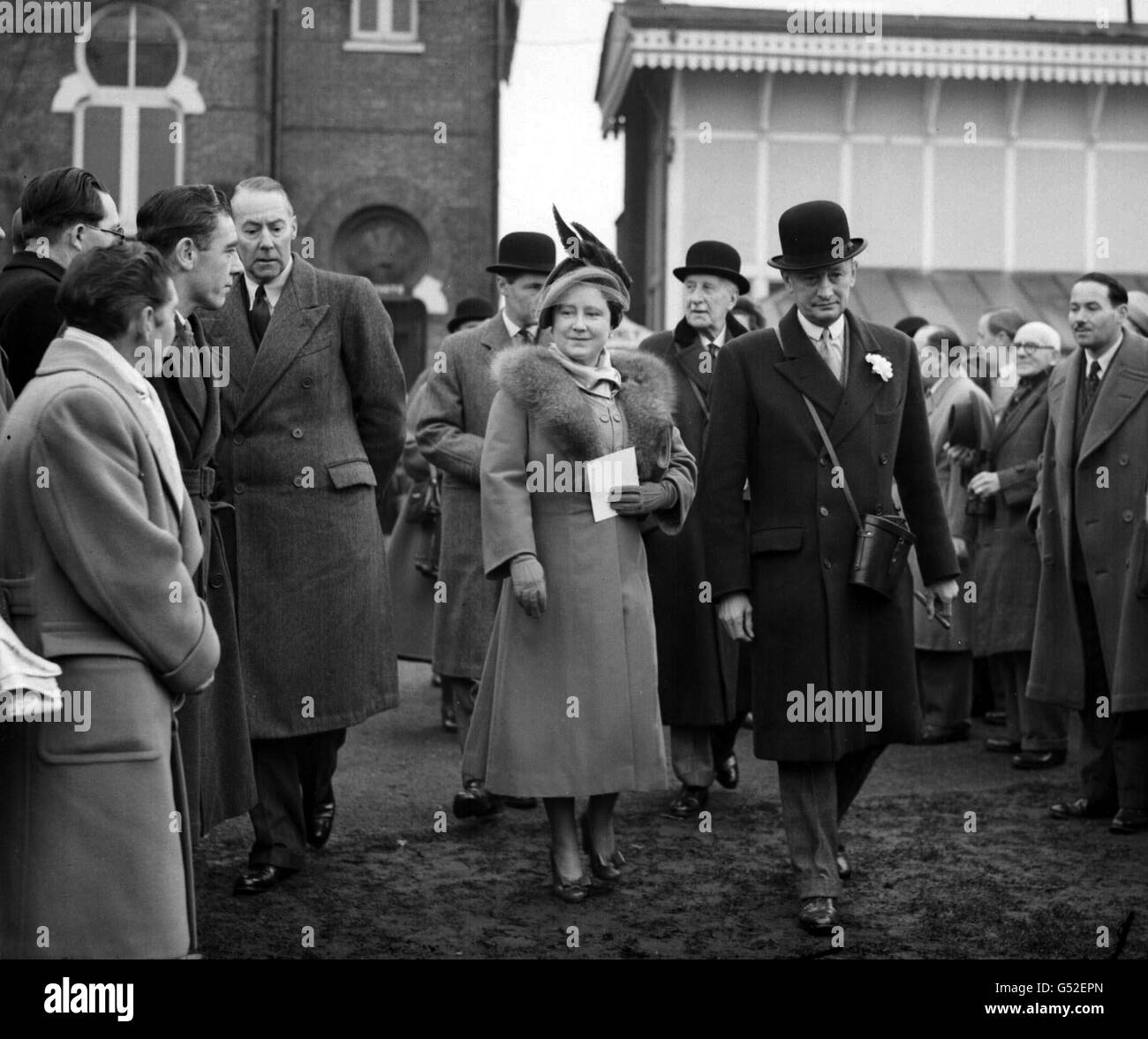 The Queen (The Queen Mother) with Sir Humphrey De Trafford in the paddock at Hurst Park races, where the Queen saw her horse Monaveen, in which she jointly owns with Princess Elizabeth (the Queen) fall in the Queen Elizabeth Steeplechase. Monaveen had to be destroyed. Stock Photo