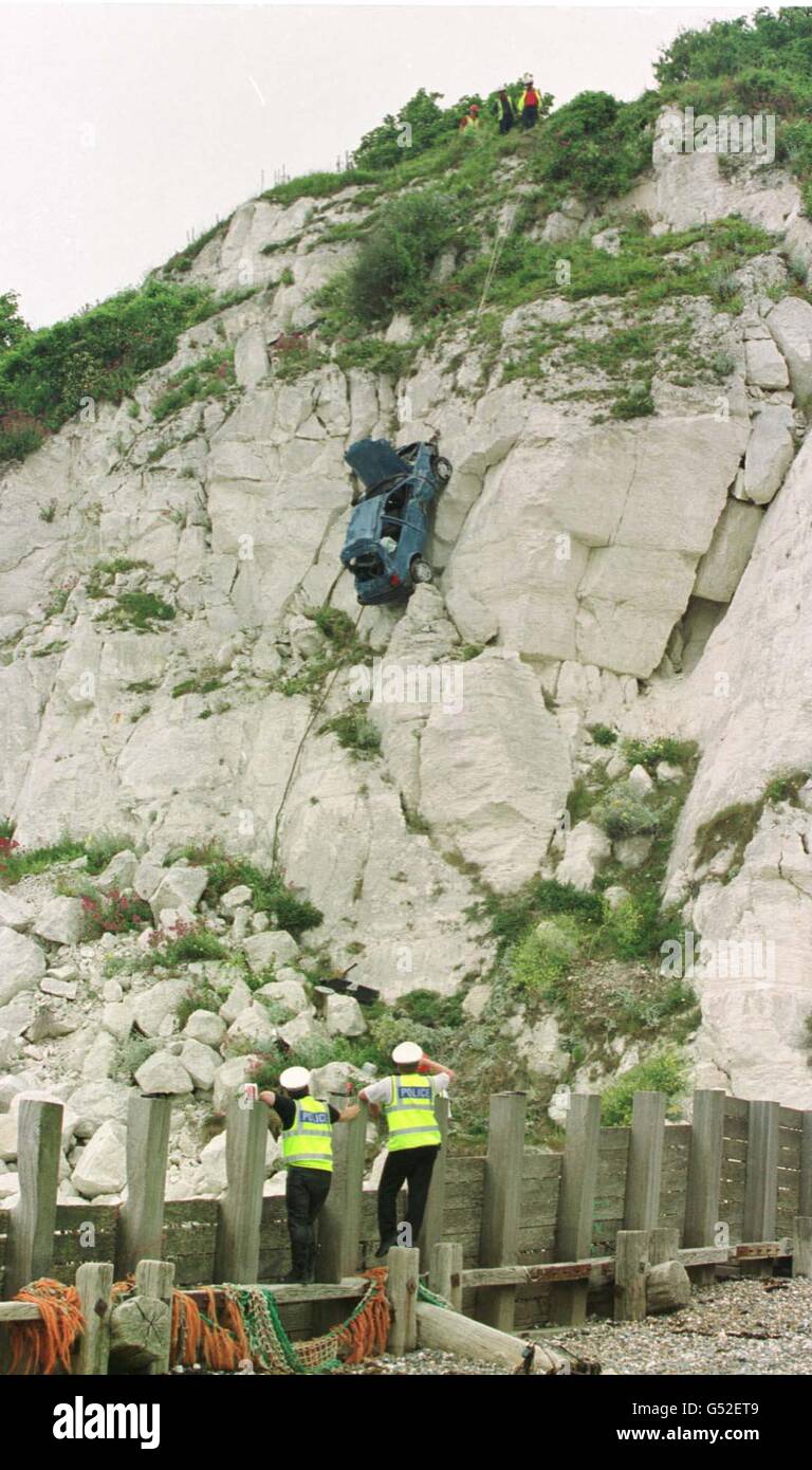Police crash investigators watch as the blue Ford Fiesta which was