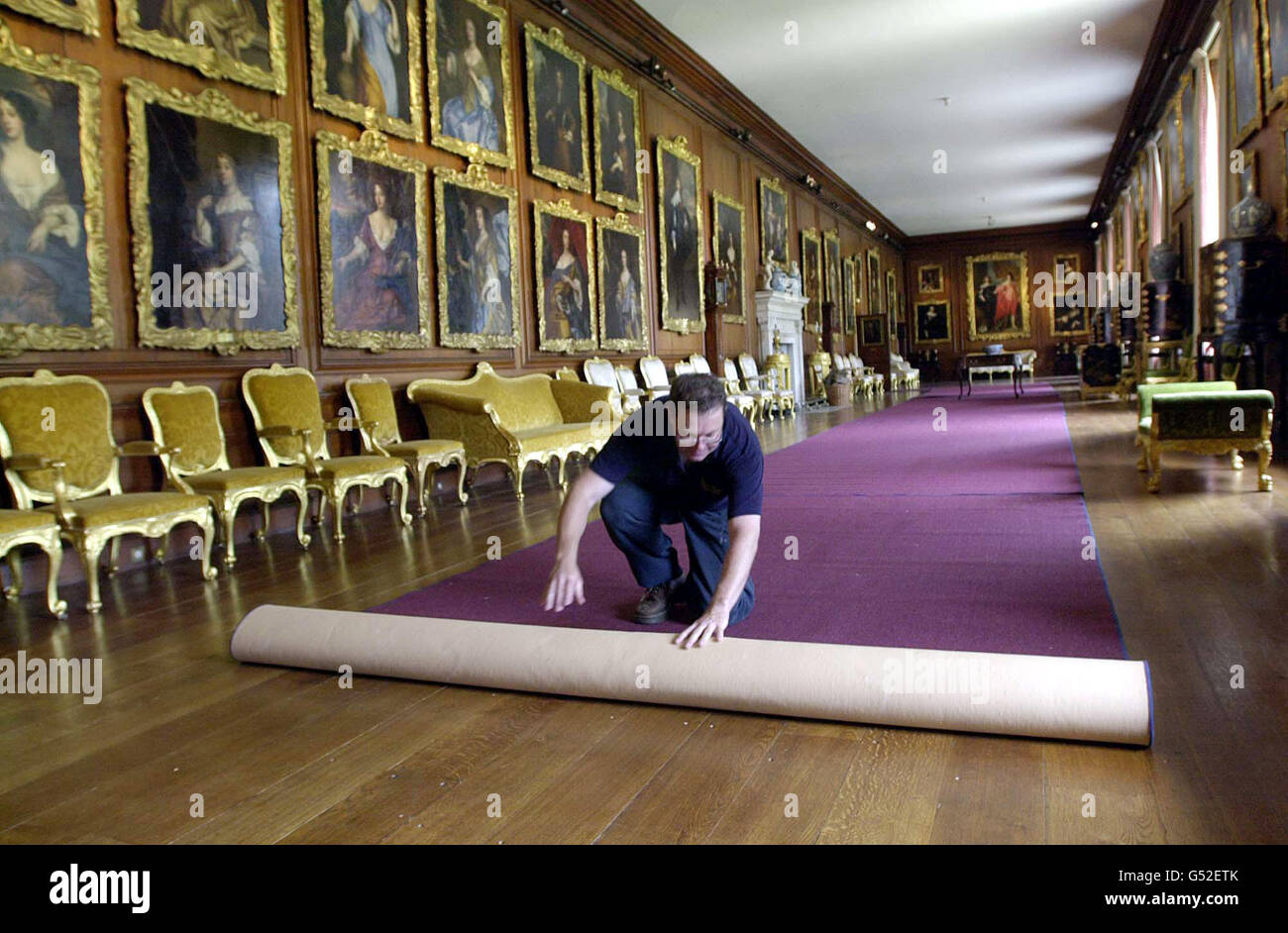 The 'Windsor beauties' gaze down as Paul Souster completes the carpet laying in preparation for the reopening of the Diana, Princess of Wales exhibition at the Spencer family home 'Althorp'. * The Picture Gallery at Althorp which includes these portraits of Charles 1's 'liaisons' and other notable works of art such as Van Dyke's 'War and Peace'are on show for the first time. Stock Photo