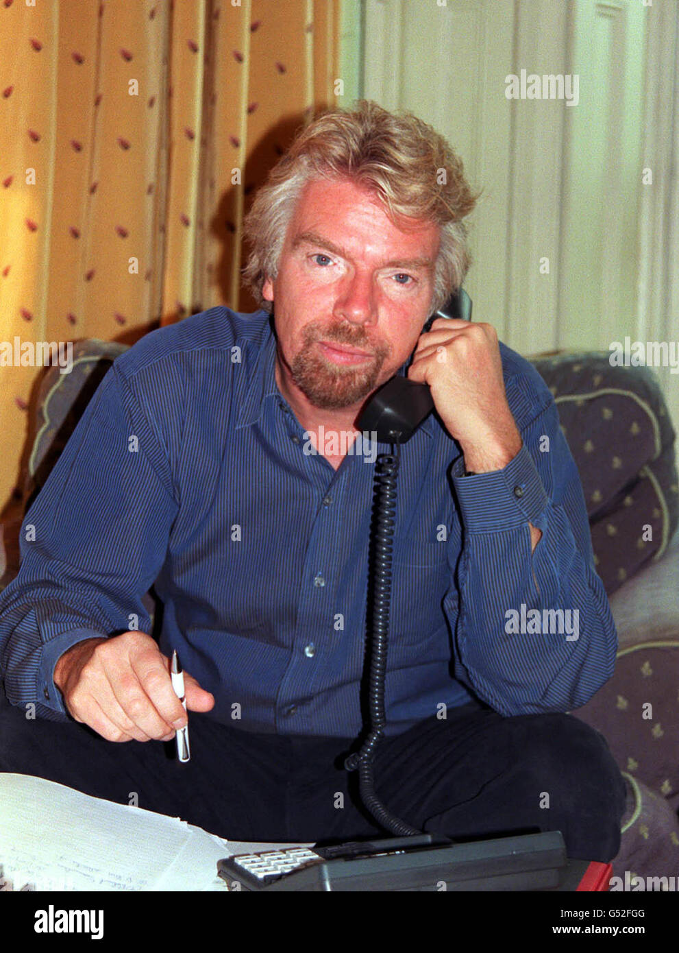 Sir Richard Branson speaks to inventor Trevor Baylis, 62, using the world's first shoes made for talking. The shoes were hailed a success when Mr. Baylis called Sir Richard Branson at his home from the Namibian Desert. *... Mr Baylis, who is on day seven of a 100-mile trek across the desert organised by the charity Mines Advisory Group, was able to generate power for the link-up from the simple motion of walking using his prototype shoes fitted with tiny dynamos. Stock Photo