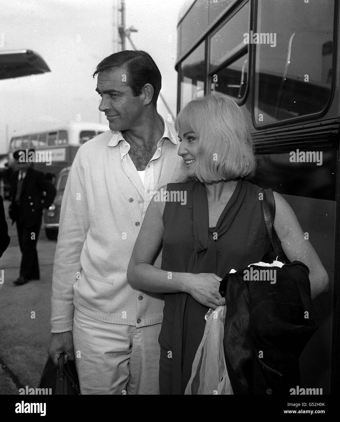 Sean Connery with his actress wife Diane Cilento arrive at London Airport after flying from Istanbul where Mr. Connery has been filming 'James Bond film 'From Russia With London' Stock Photo
