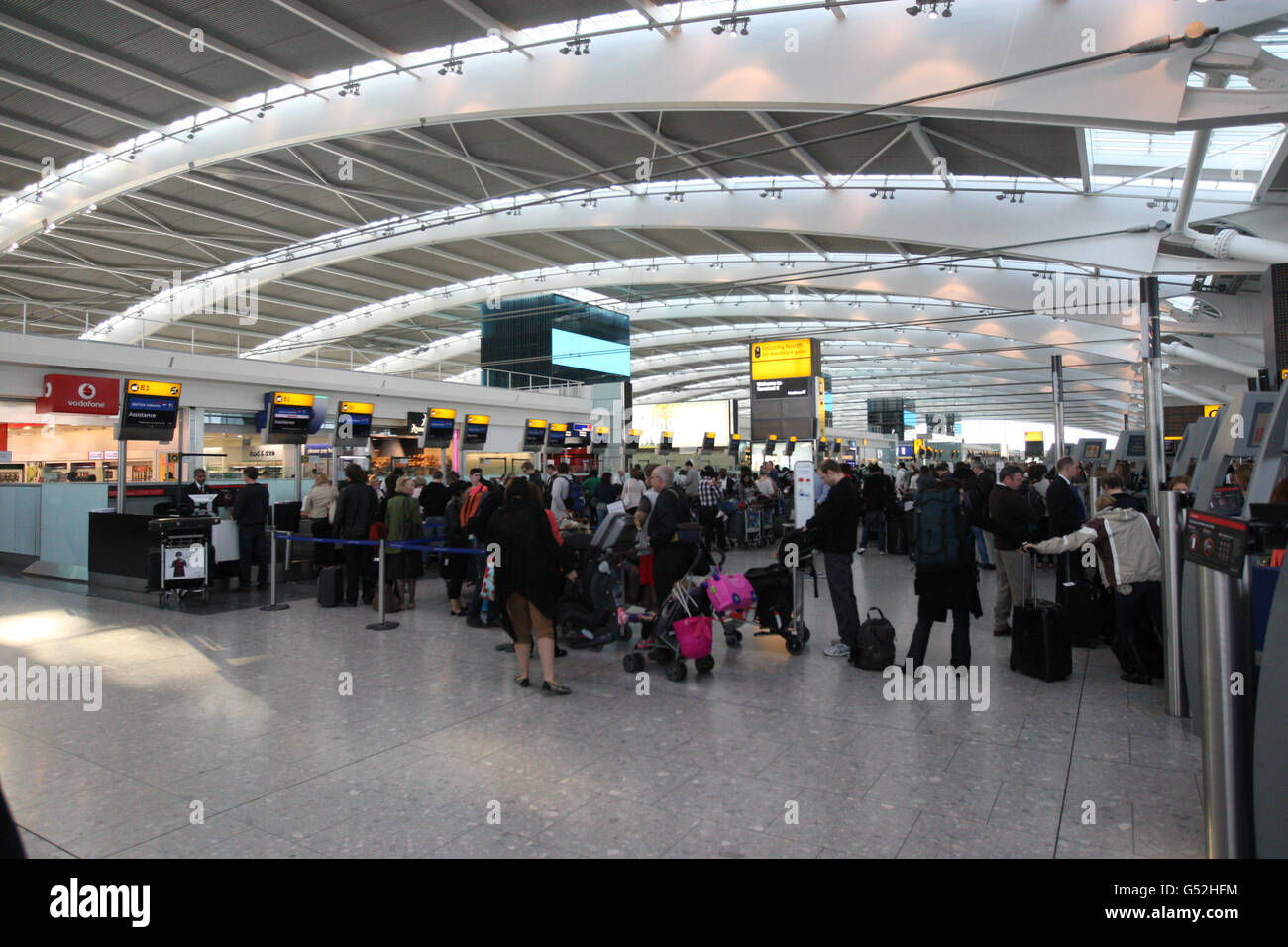 Passengers queue at check in desks to drop there bags off in Terminal 5