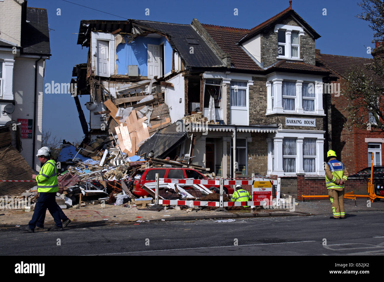 Fire and Rescue workers survey the scene at a house, divided into three