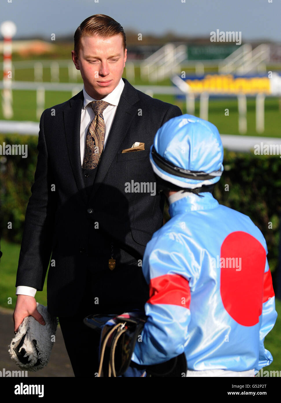 Trainer Scott Dixon talks to jockey Billy Cray after their horse finished unplaced in The William Hill App - Download Today! Handicap Stakes during the William Hill Lincoln meeting at Doncaster Racecourse, Doncaster Stock Photo