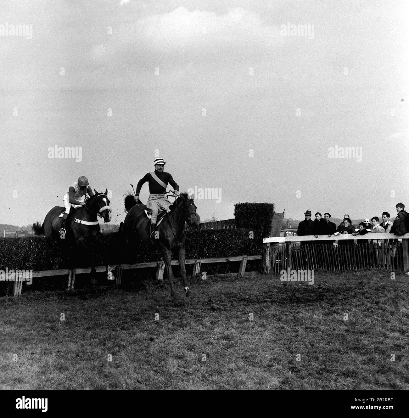 Mr T.F. Phillips's Prilliard (r) clearing the fence to win The 'Clapper' Hunters' Challenge Cup at Plumpton. Stock Photo
