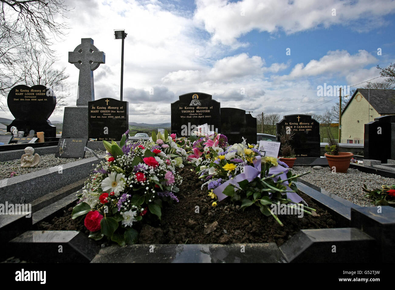 Flowers on the grave of Margaret McGuire in St Mary's church, Culdaff, Co Donegal, as health chiefs remain concerned about a small number of residents who are ill at the private Nazareth House care home at Fahan, near Buncrana, Co Donegal, where six people have died in a suspected viral outbreak. Stock Photo