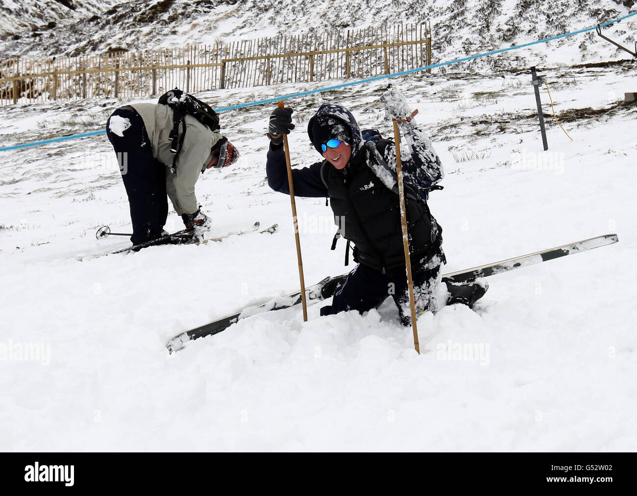 Sam Cunningham (front), from Perth, pulls himself up after falling over at the Glenshee Ski resort in the Cairngorms. Stock Photo