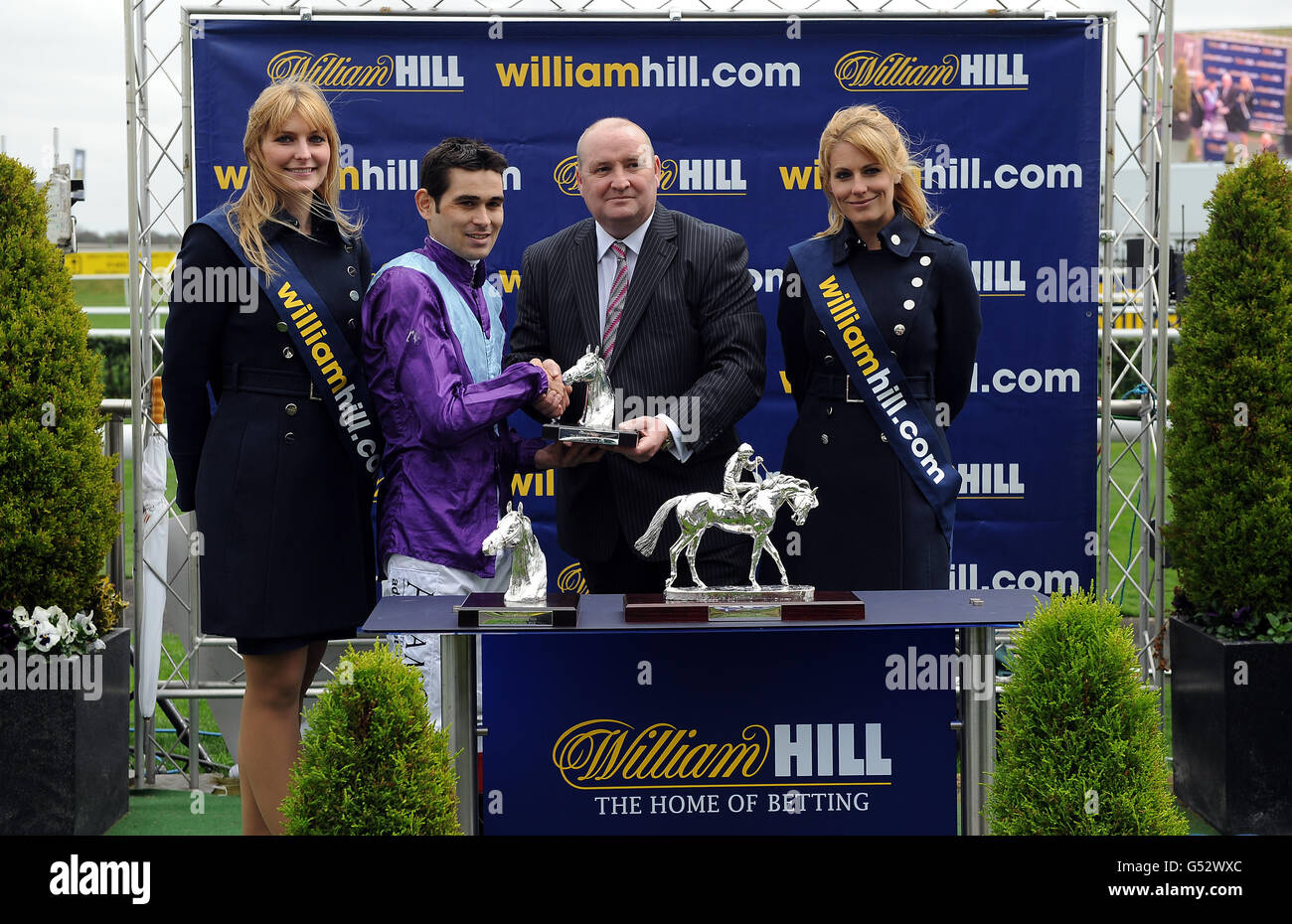 Jockey Lee Newman collects his trophy after winning The William Hill Spring Mile on Norse Blues during the William Hill Lincoln meeting at Doncaster Racecourse, Doncaster Stock Photo