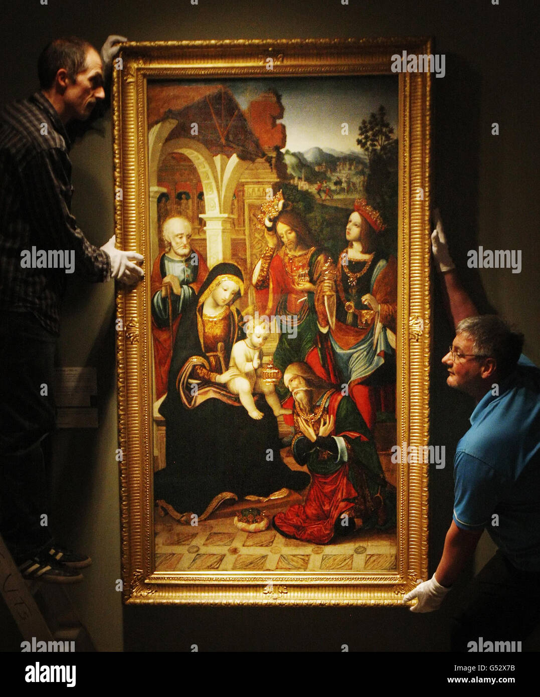 Logistics Technician David Coia (left) and Lighting Technician Fraser Campbell (right) are pictured next to painting Adoration of the Magi, ahead of the opening of exhibition Essence of Beauty: 500 years of Italian Art, at the Kelvingrove Art Gallery and Museum in Glasgow. Stock Photo