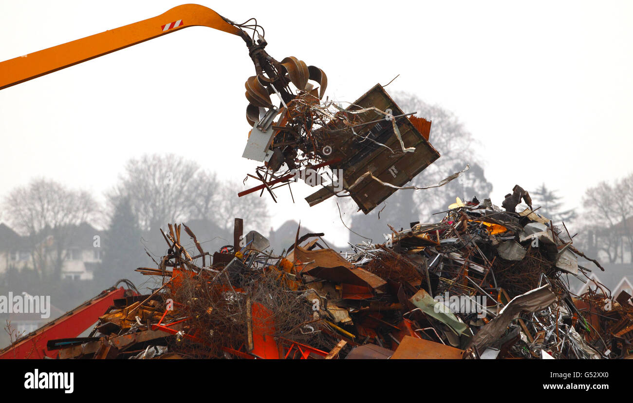 Scrap Metal Depot. A crane drops scrap metal onto a large pile at a