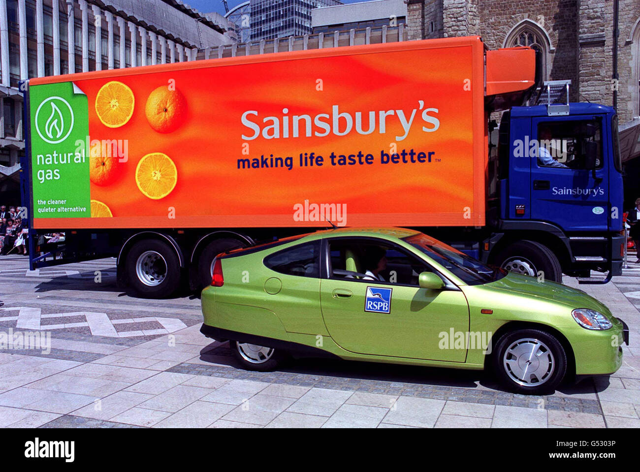 An environmentally friendly RSPB Honda petrol electric car with a Sainsbury's natural gas truck