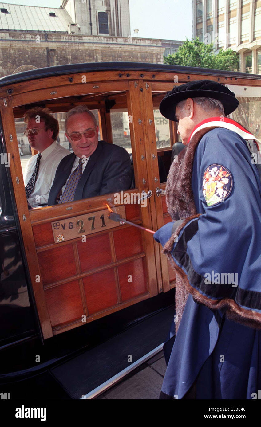 Master Carman John Silbermann at the annual cart marking ceremony in Guildhall Yard, London, embossing the City Arms and a year letter on the wooden door of a 1932 Ford Model A Woody Station Wagon. Stock Photo