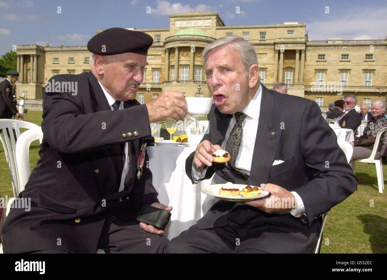 Normandy veteran and former gunner Bill Collins, 81, of Cork, shares afternoon tea with Sir Norman Wisdom during the 'Not Forgotten Garden Party', attended by the Princess Royal in the grounds of Buckingham Palace. Stock Photo