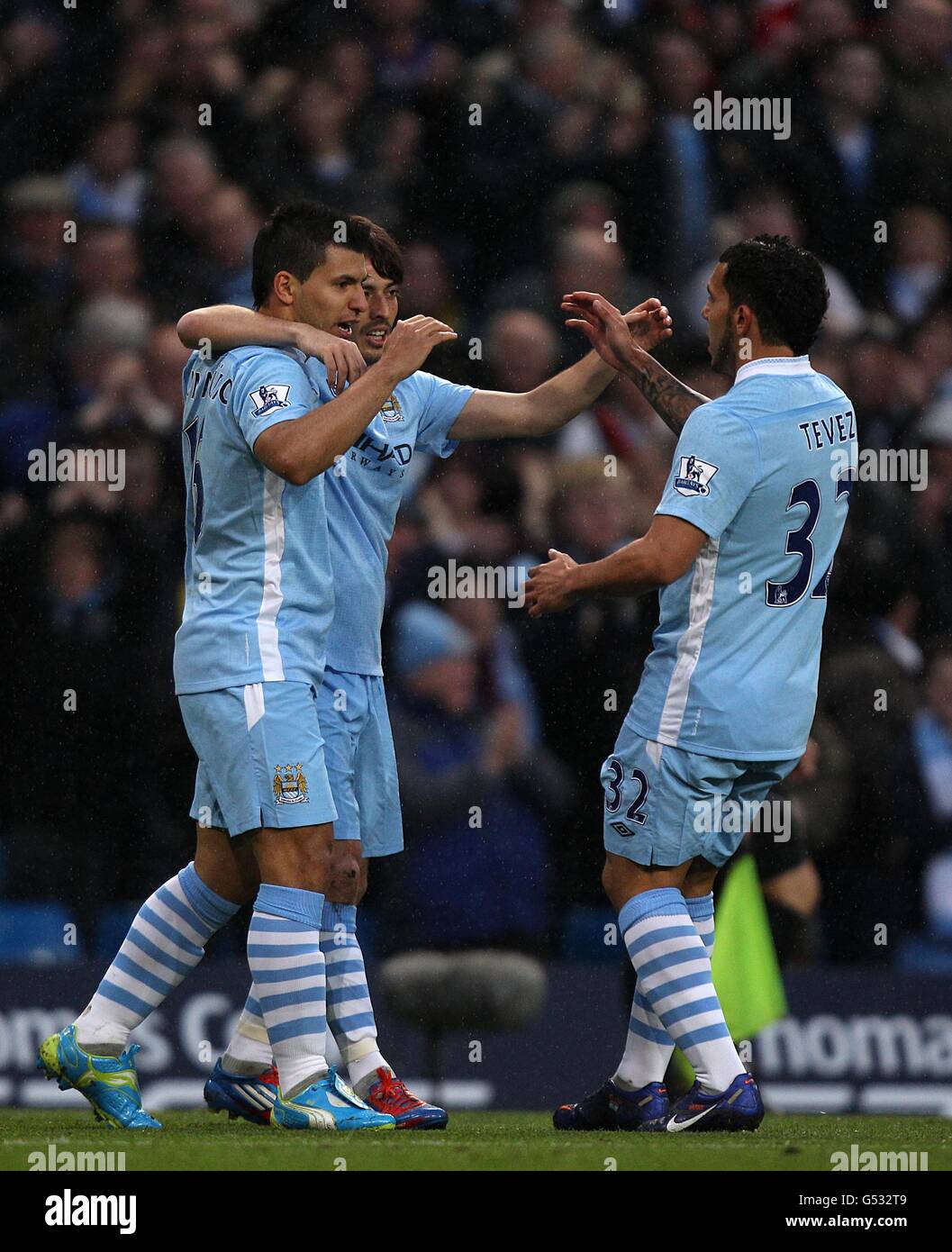 Manchester City's Sergio Aguero celebrates scoring the opening goal of the game with David Silva and Carlos Tevez (right) Stock Photo