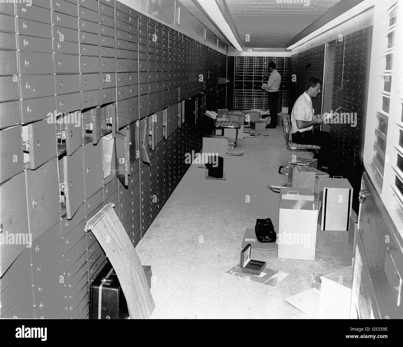 Police officers check the raided boxes in the vault of the Knightsbridge Safe Deposit Centre in London following the 40 million robbery. Stock Photo
