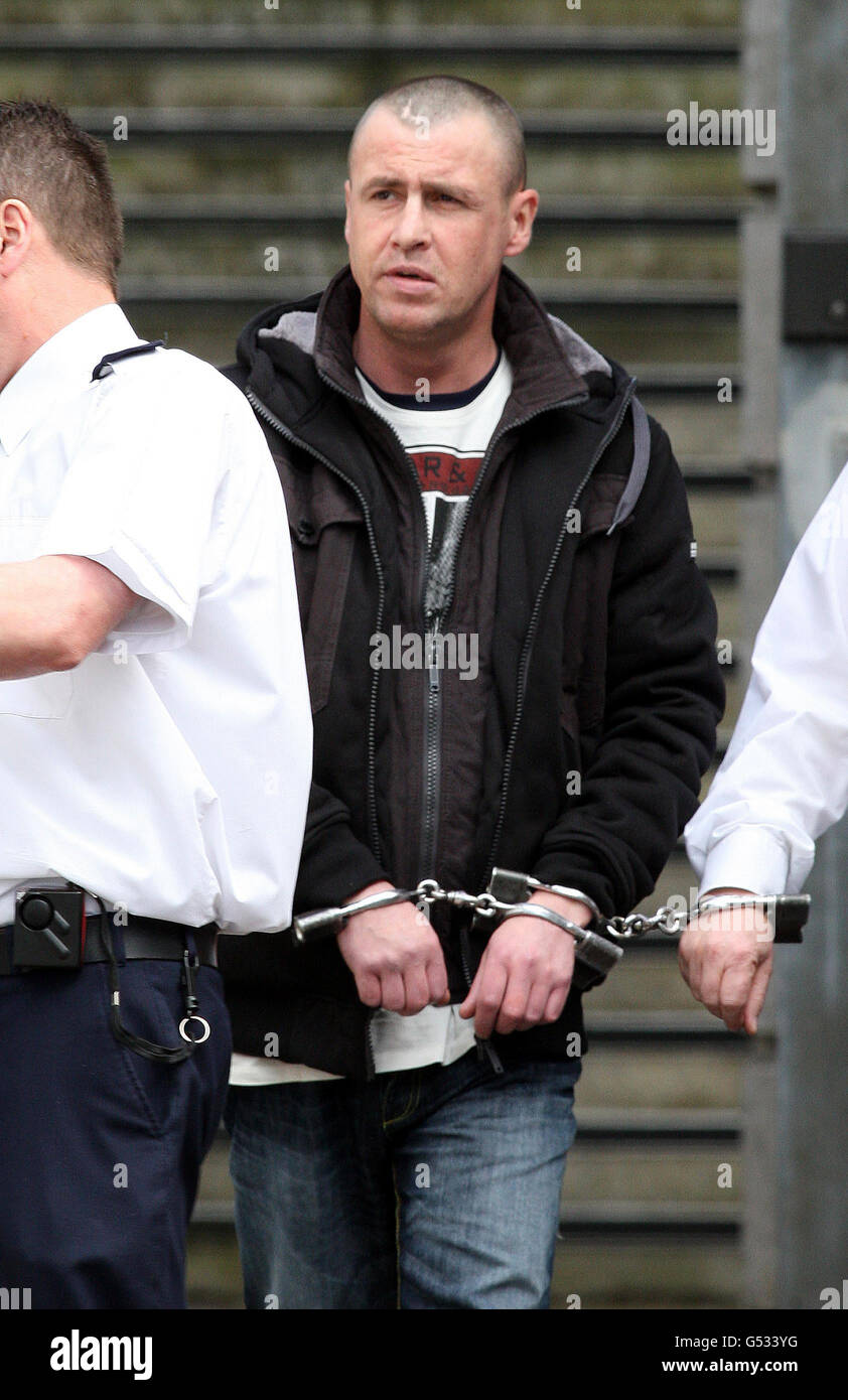 James Alexander McCook is led away in handcuffs from Ballymena Magistrates Court, after he accused of stabbing Norman Moffatt, 73, as the pensioner walked home after buying his morning newspaper in Coleraine, Co Londonderry, in January 2001. Stock Photo