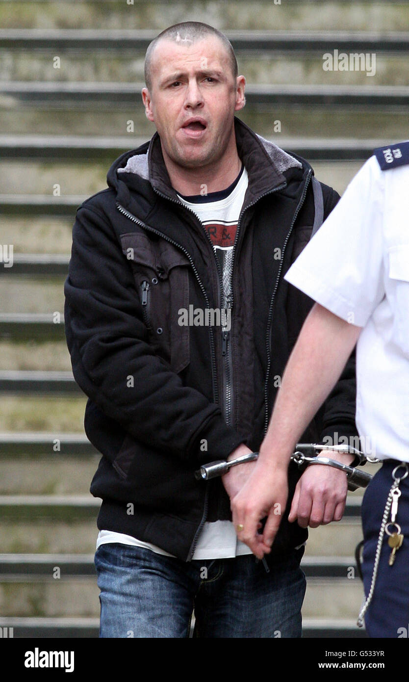 James Alexander McCook is led away in handcuffs from Ballymena Magistrates Court, after he accused of stabbing Norman Moffatt, 73, as the pensioner walked home after buying his morning newspaper in Coleraine, Co Londonderry, in January 2001. Stock Photo