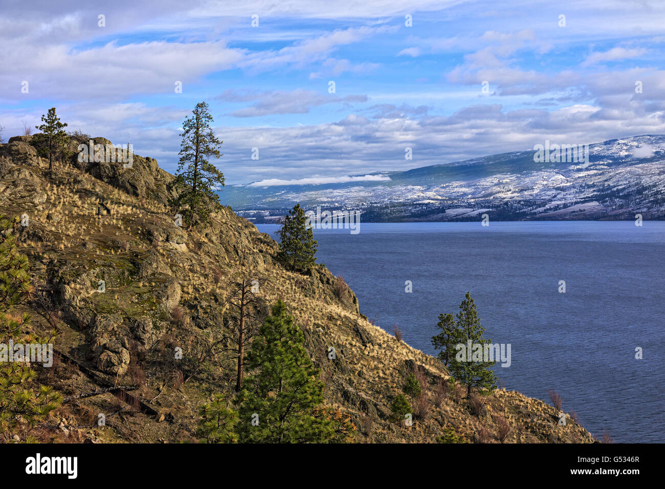 Okanagan Lake Kelowna British Columbia Canada in the winter with snowy mountains in the background Stock Photo