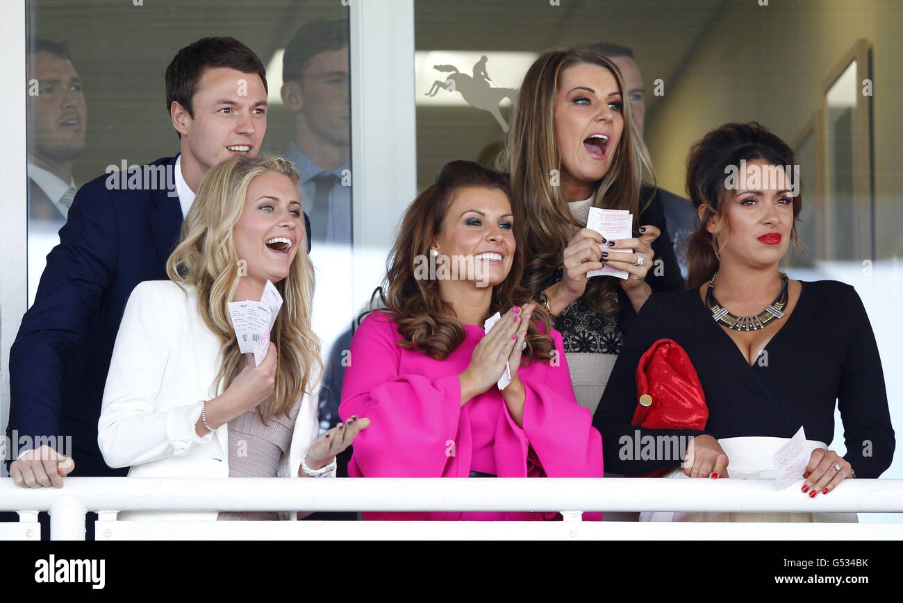 Hayley Fletcher (second from right) wife of Manchester United footballer Darren Fletcher, celebrates winning a race alongside Jonny Evans (left) and Wayne Rooney's wife Coleen (centre) and two unidentified women during day one of the 2012 John Smith's Grand National meeting at Aintree Racecourse, Liverpool. Stock Photo