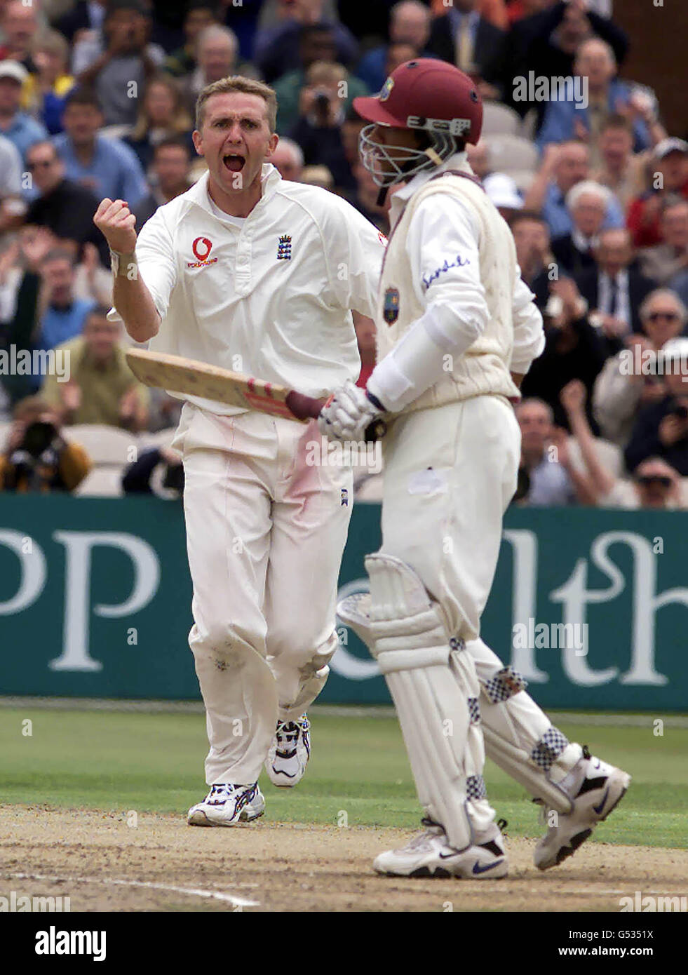 England bowler Dominic Cork celebrates after trapping Ramnaresh Sarwan