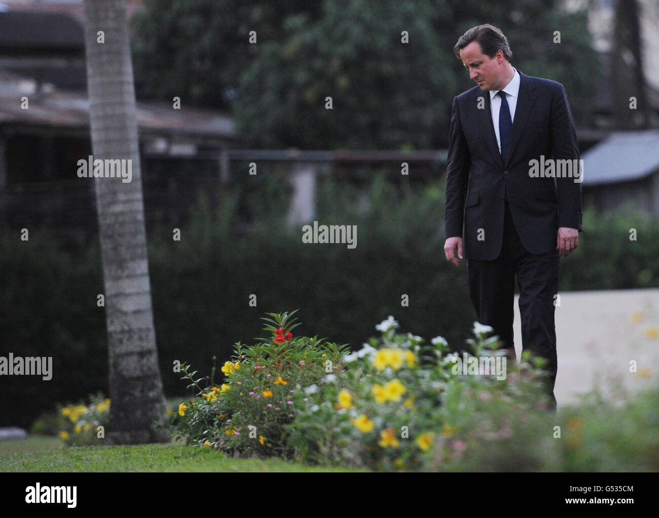 Prime Minister David Cameron walks through Htaukkyam the Cemetery in ...