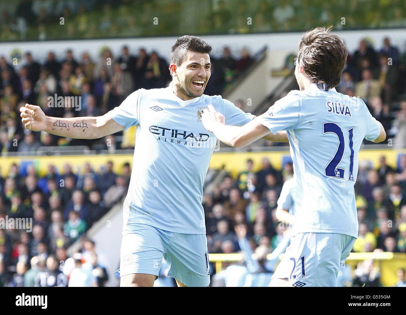 Manchester City's Sergio Aguero celebrates after scoring their fourth goal with team mate David Silva (right) Stock Photo