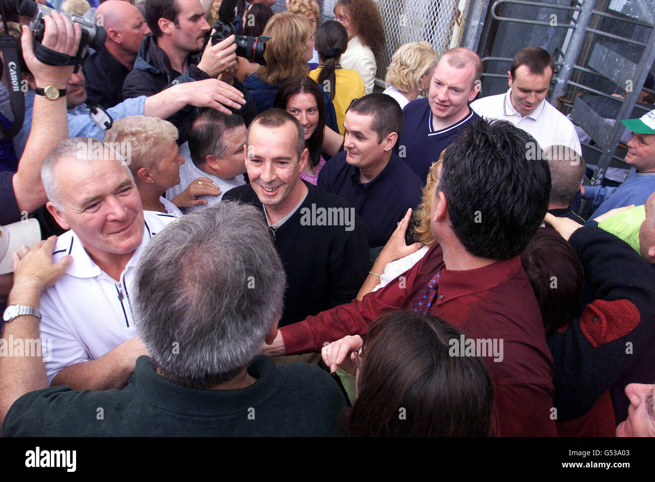 IRA Prisoners emerge through the prison turnstile, greeted by friends and family at the Maze, near Lisburn, county Antrim, as the final wave of terrorist prisoners early release from Northern Ireland's jails began. Just 15 inmates will remain inside the Maze. Stock Photo