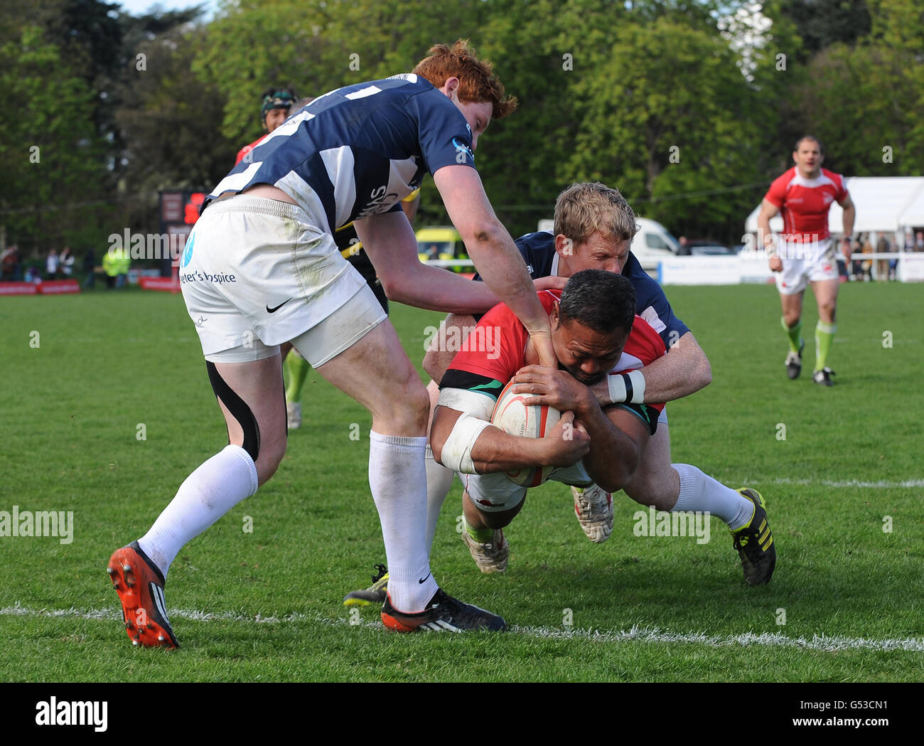 London Welsh's Vili Ma'asi powers towards the try line to score his first try as he is tackled by Bristol's Tom Slater (right) and Jack Tovey (left) Stock Photo