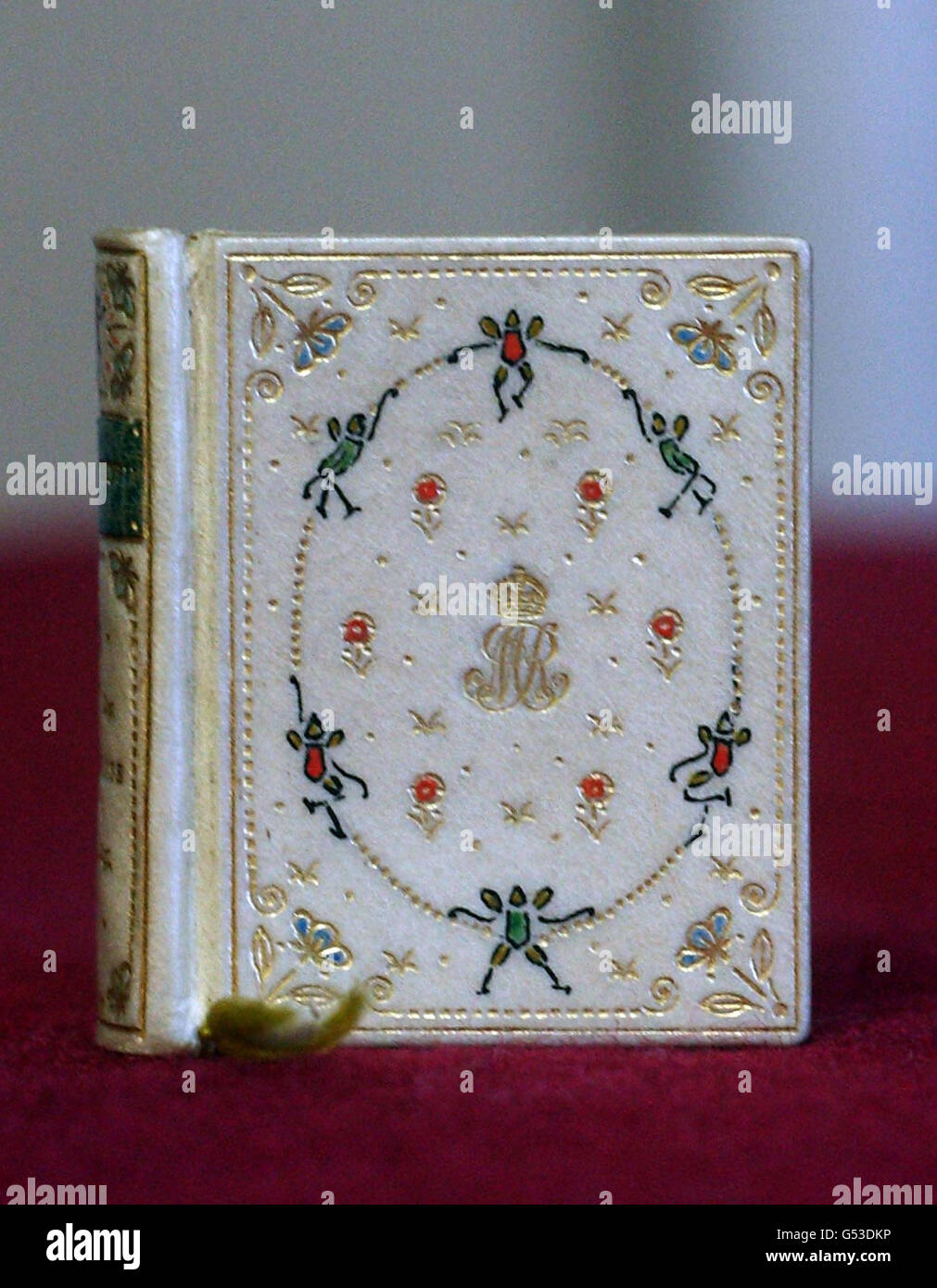 A miniature book made especially for Queen Mary's Dolls' House at Windsor Castle, which measures 4cm by 3.5cm containing a fairy story which has been reproduced for the first time. Stock Photo