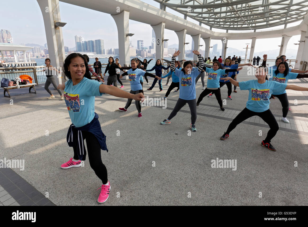Southeast Asian women dancing Zumba on pier, Filipino housemaid Sunday, Hong Kong Island, Hong Kong, China Stock Photo