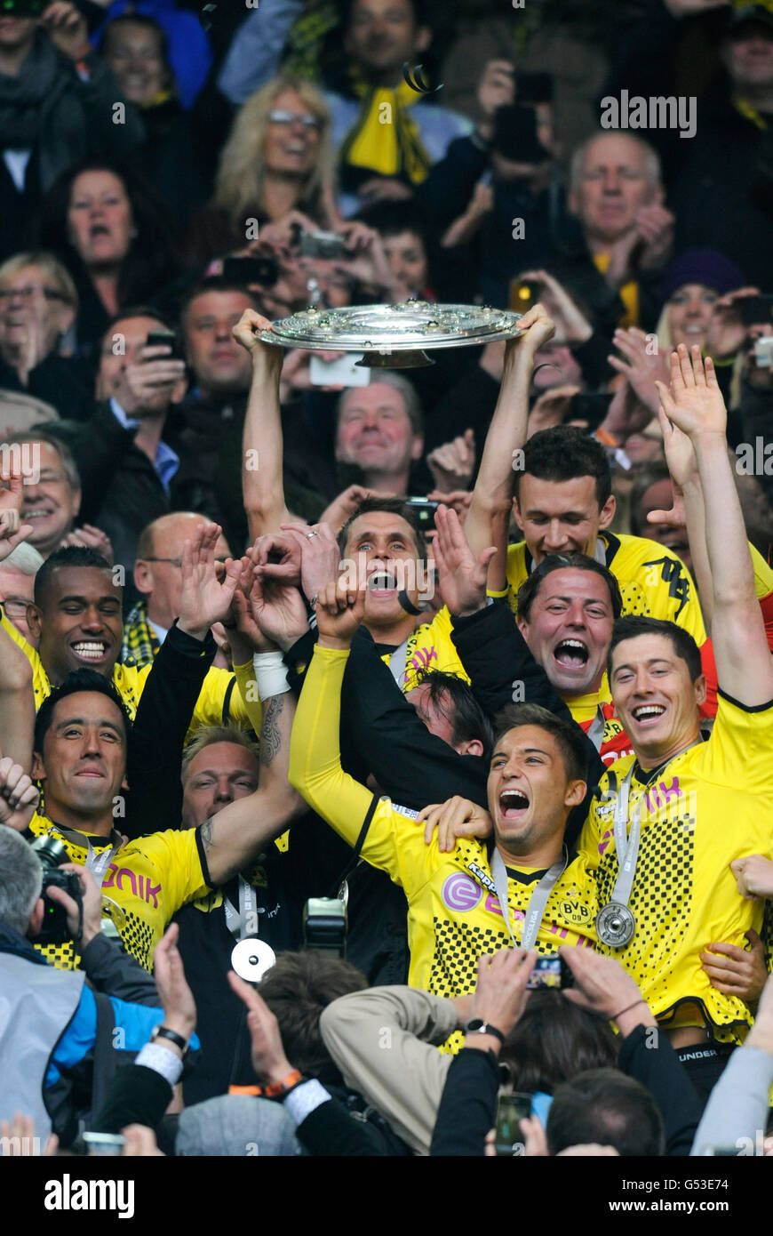 Cheering footballers of BVB Borussia Dortmund with the league cup trophy, after match Borussia Dortmund vs SC Freiburg (4:0) Stock Photo