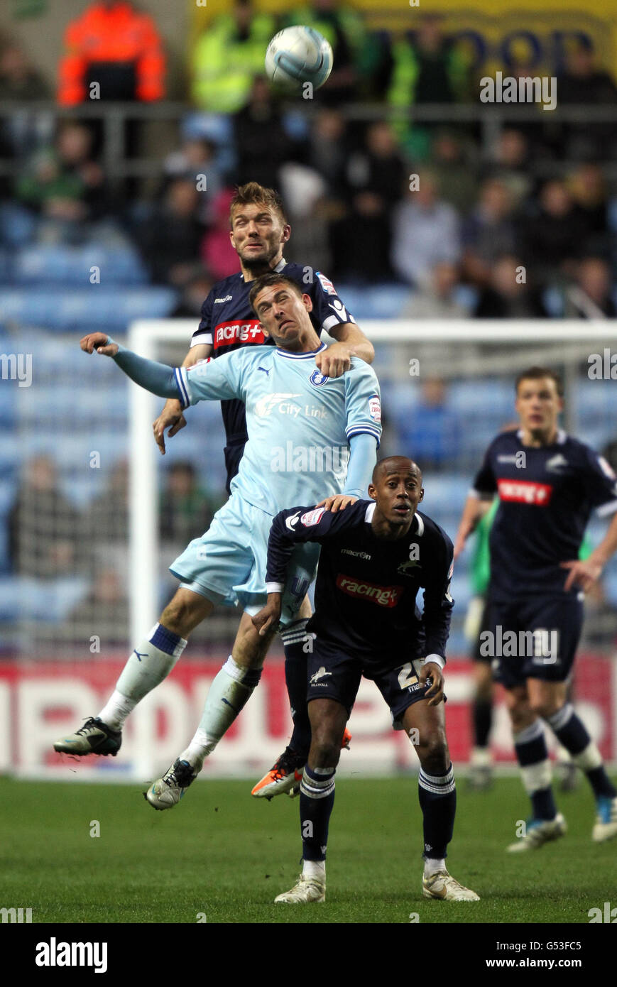 Coventry's Cody McDonald loses a header to Millwall's Darren Ward during the npower Football League Championship match at the Ricoh Arena, Coventry. Stock Photo