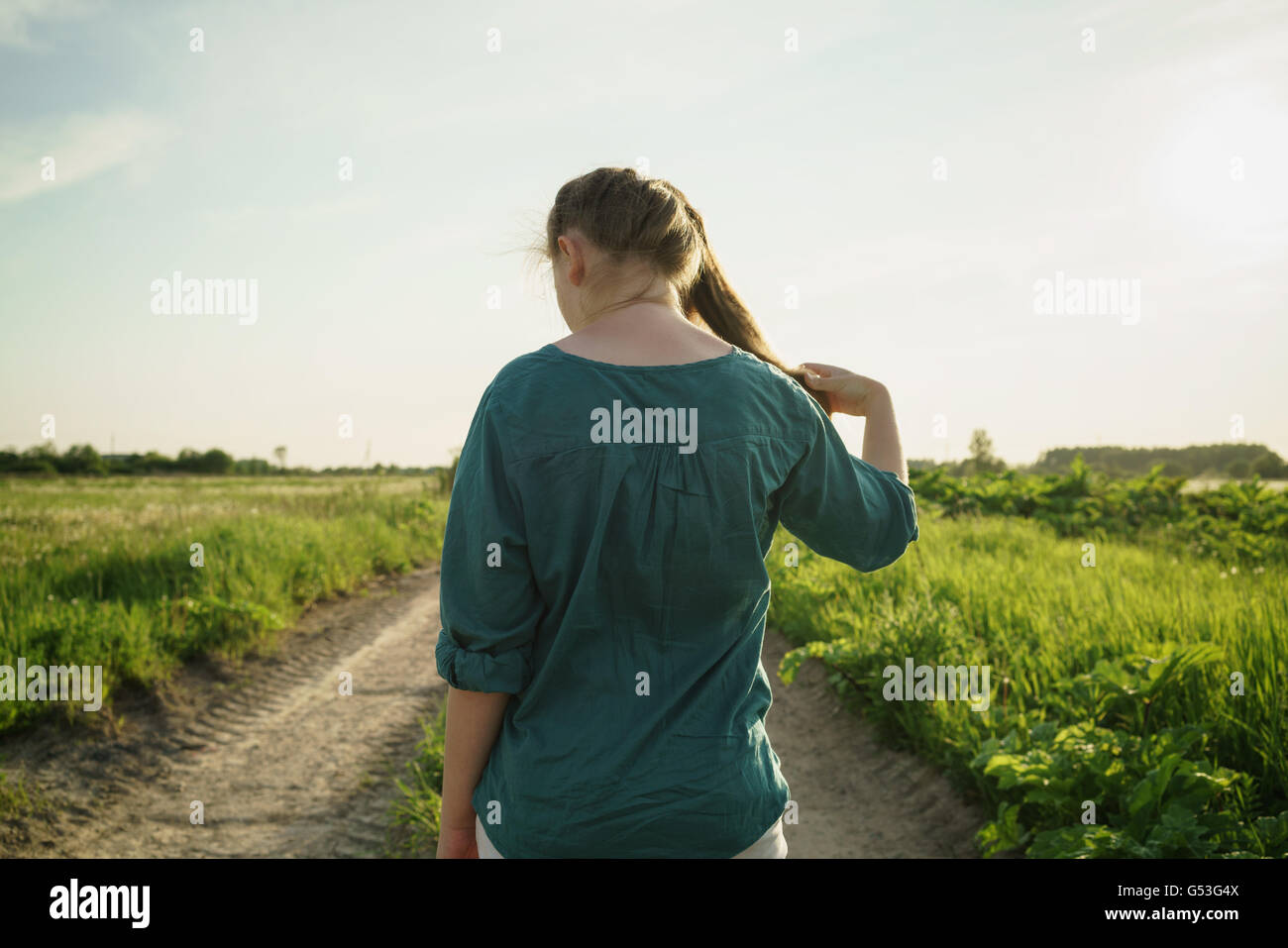 Back view teen girl walking hi-res stock photography and images - Alamy