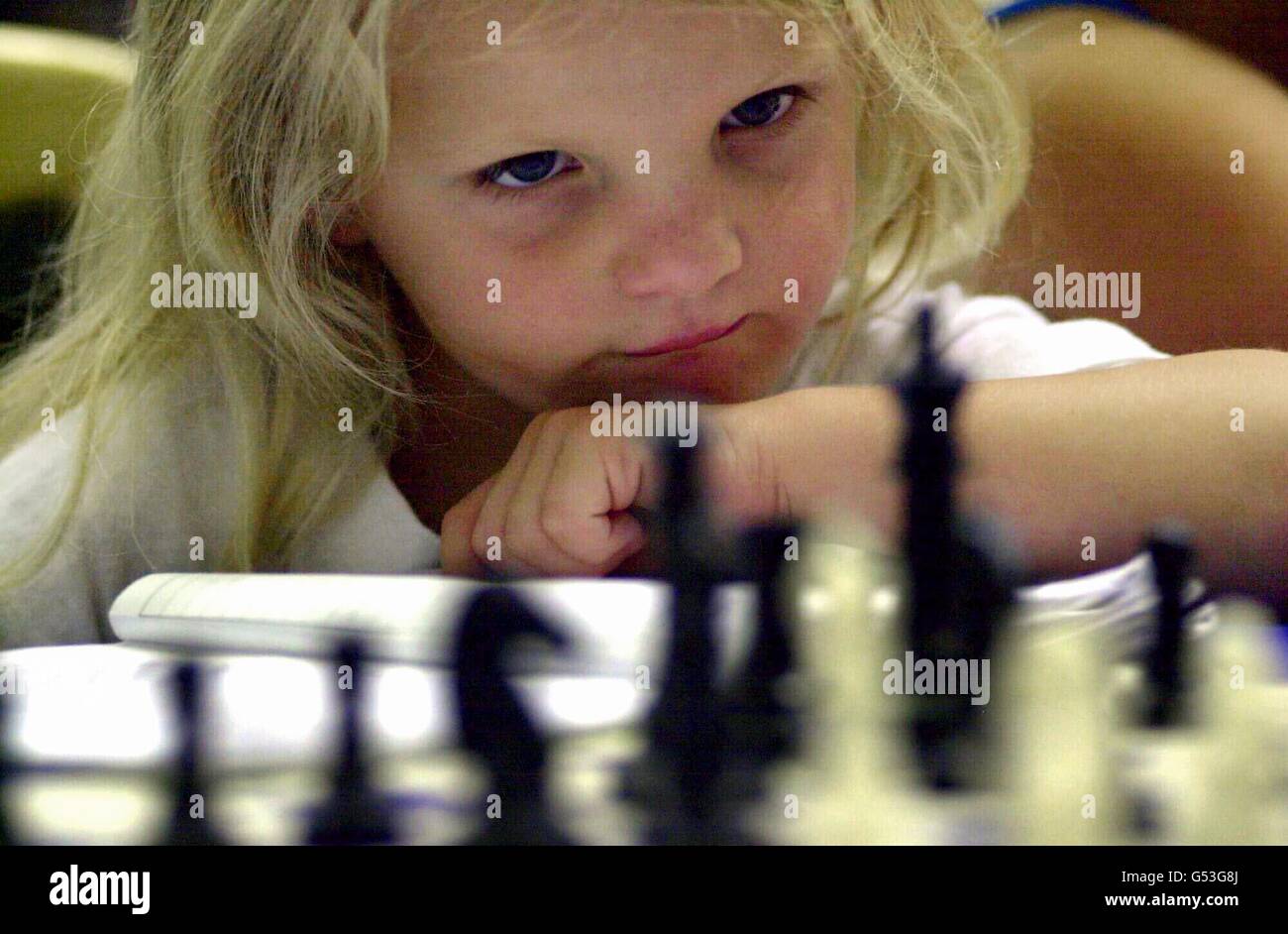 Five-year-old Samantha Hale from Thomas Willingale School in Essex takes part in a mass chess championship during the Mind Sports Olympiad at the Alexandra Palace in London where she is the youngest competitor. Stock Photo