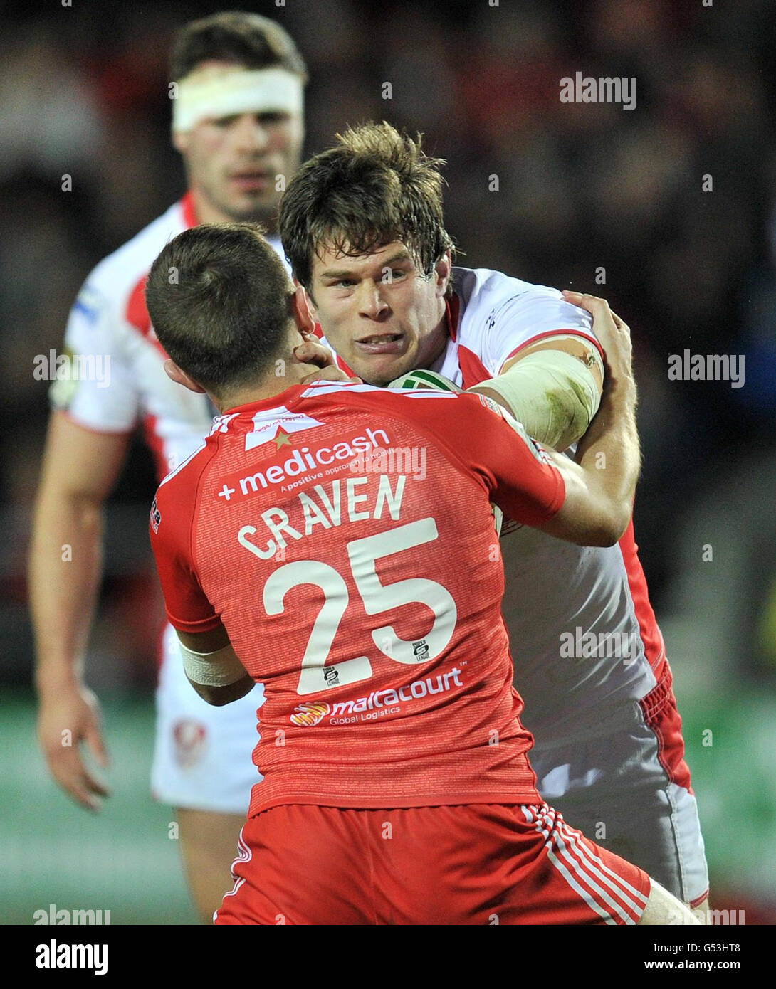 St Helens Louie McCarthy-Scarsbrook is tackled by Widnes' Danny Craven (left) during the Stobart Super League match at Langtree Park, St Helens. Stock Photo