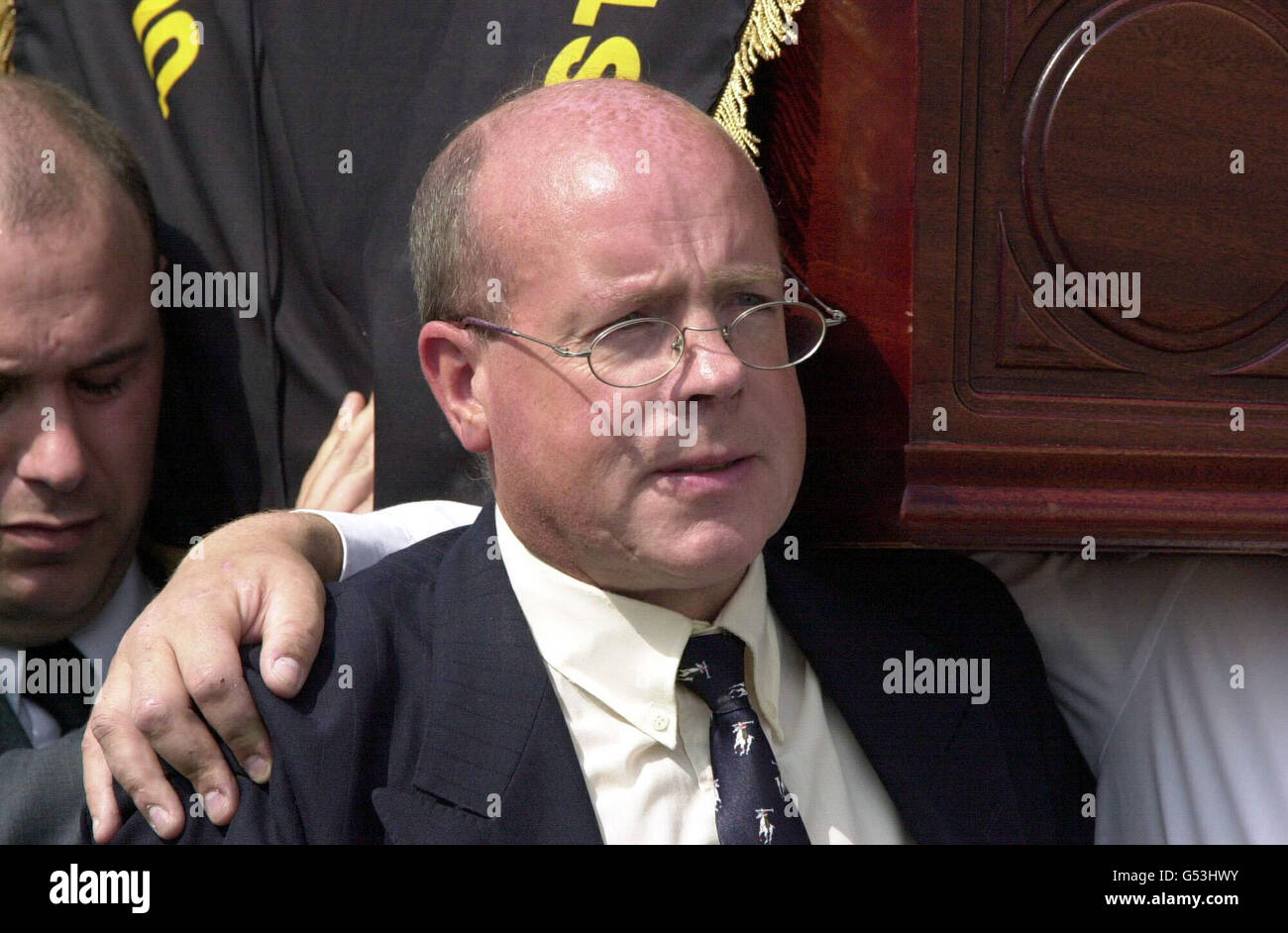 Ulster Democratic Party chairman John White carries the coffin of