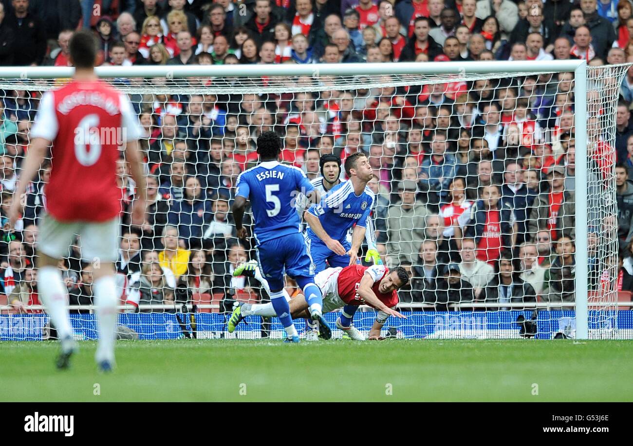 Arsenal's Robin van Persie (right) goes down in the penalty area after a collision with Chelsea's Gary Cahill (second right) Stock Photo