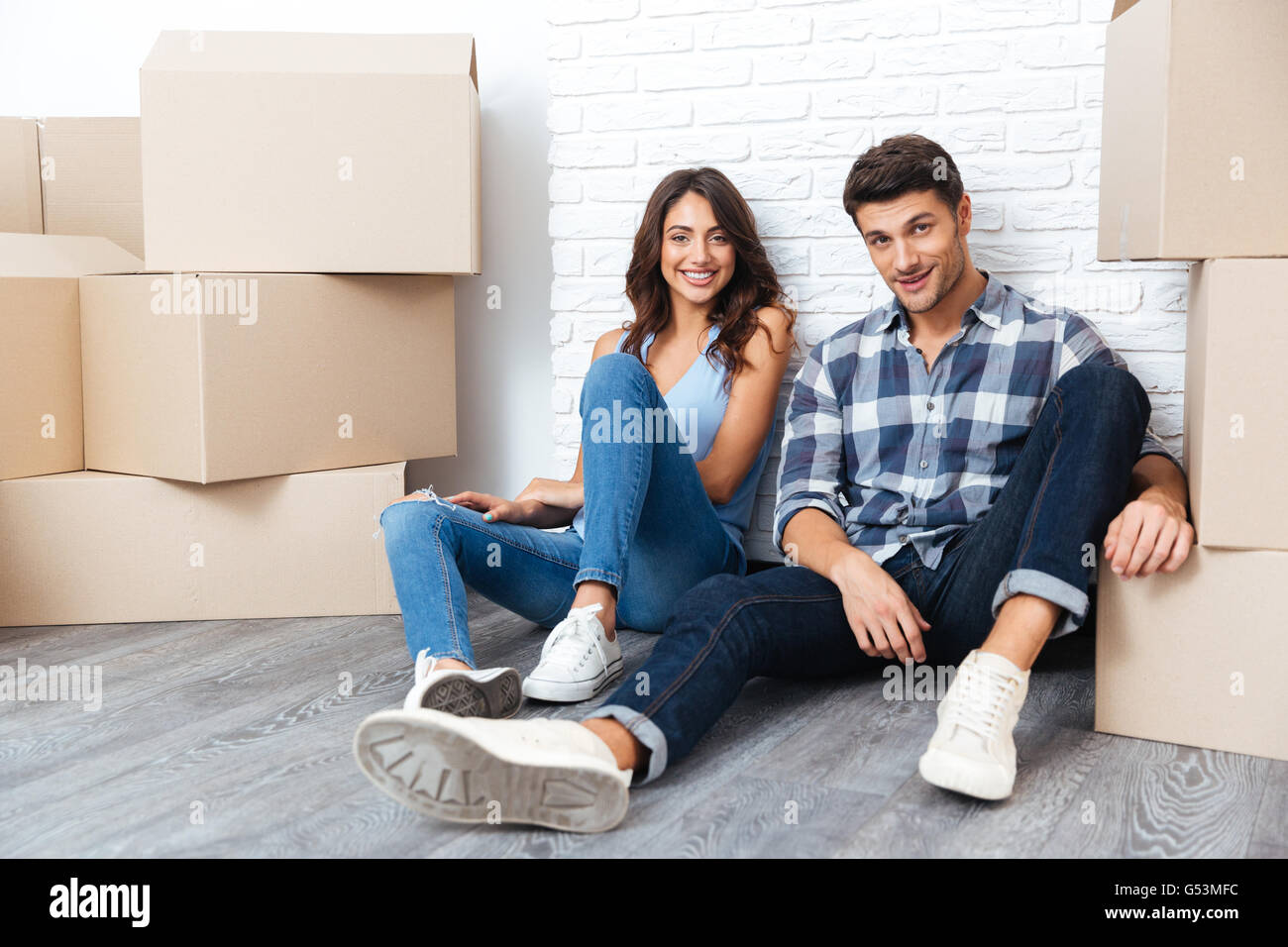 Young happy couple moving to new flat Stock Photo - Alamy
