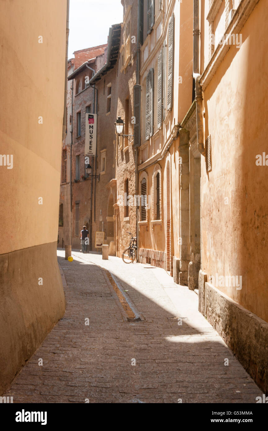 A tiny cobbled street in the old town of Toulouse, home to the city museum Stock Photo